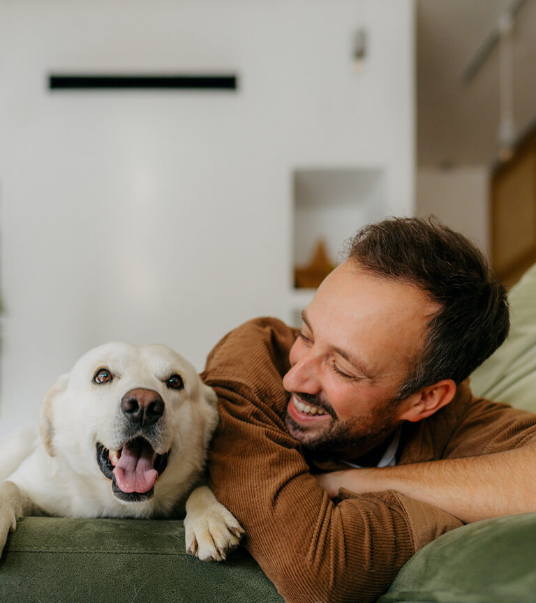 man smiling at his dog